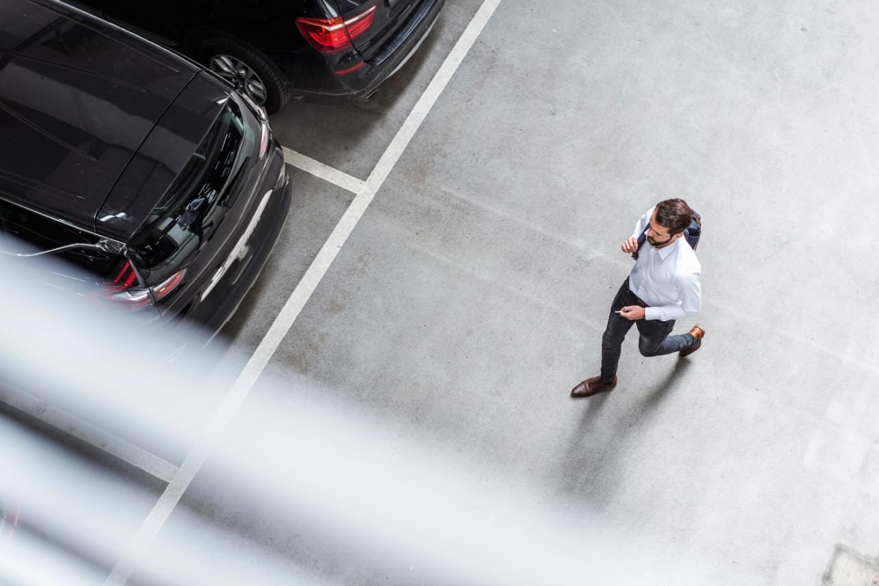 businessman-backpack-running-to-car-getty-970176622